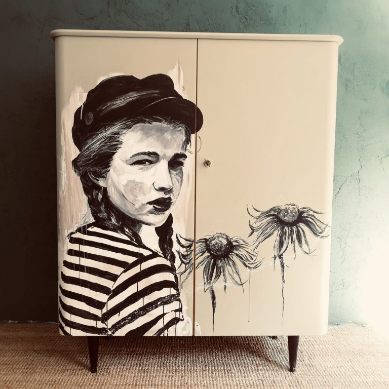 Ein Schrank mit einem grafischen Design eines Mädchens in gestreiftem Shirt und Blumen.